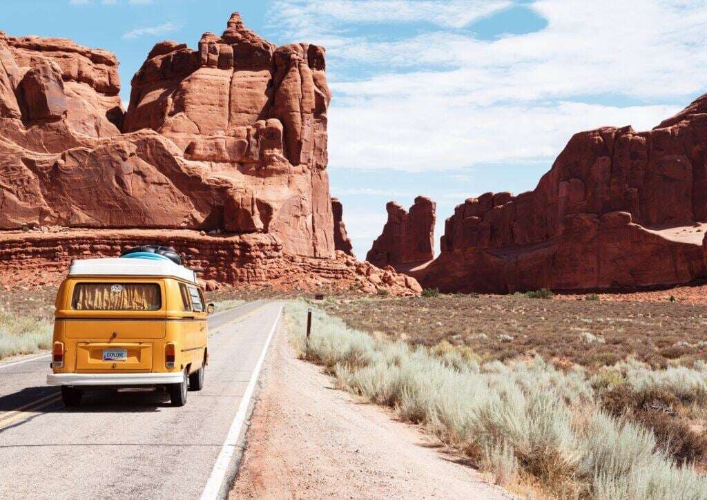 Image of a VW bus traveling through canyon scenery