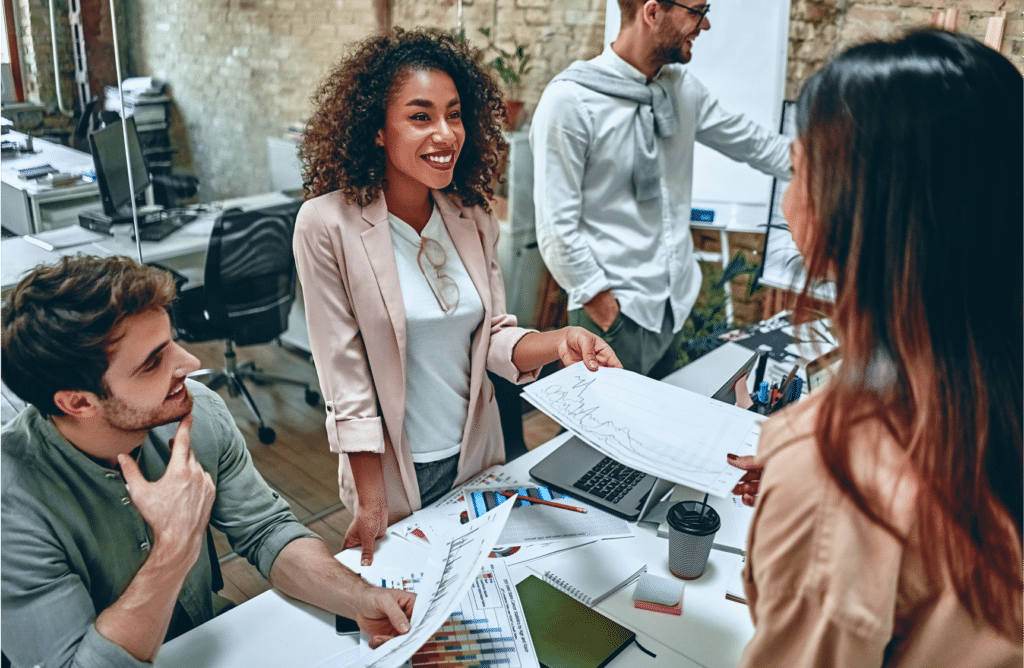 Picture shows team members showing great communication during a meeting in person.