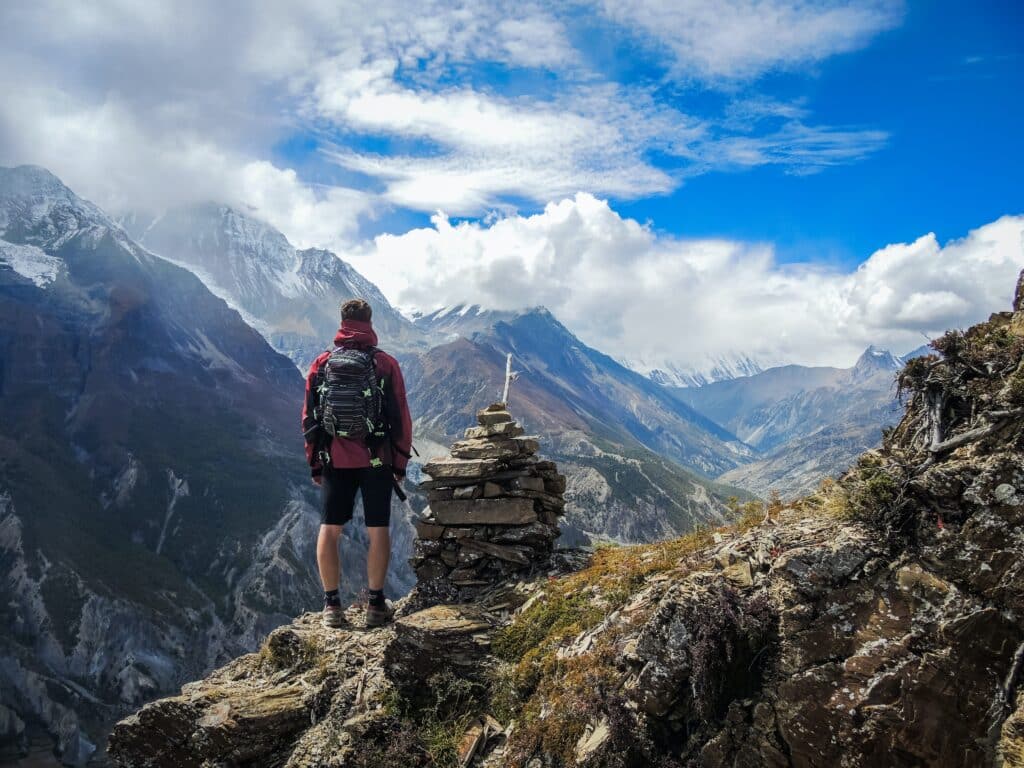 Image of a backpacker in a beautiful mountain location--he remembered his portable battery pack.y
