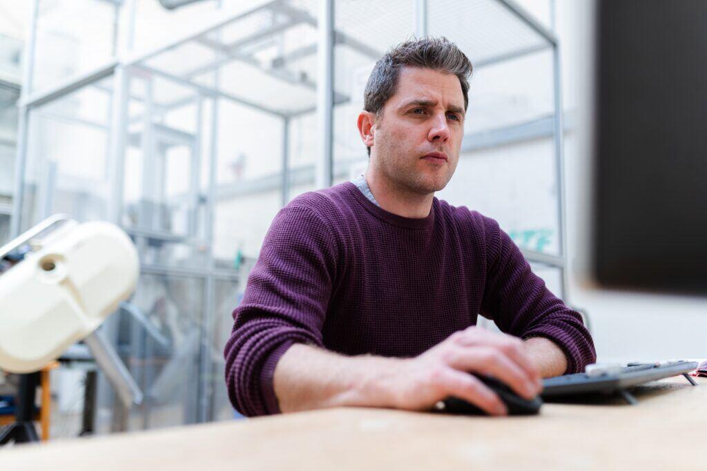 Image of a man perusing the new names of features within Microsoft Purview