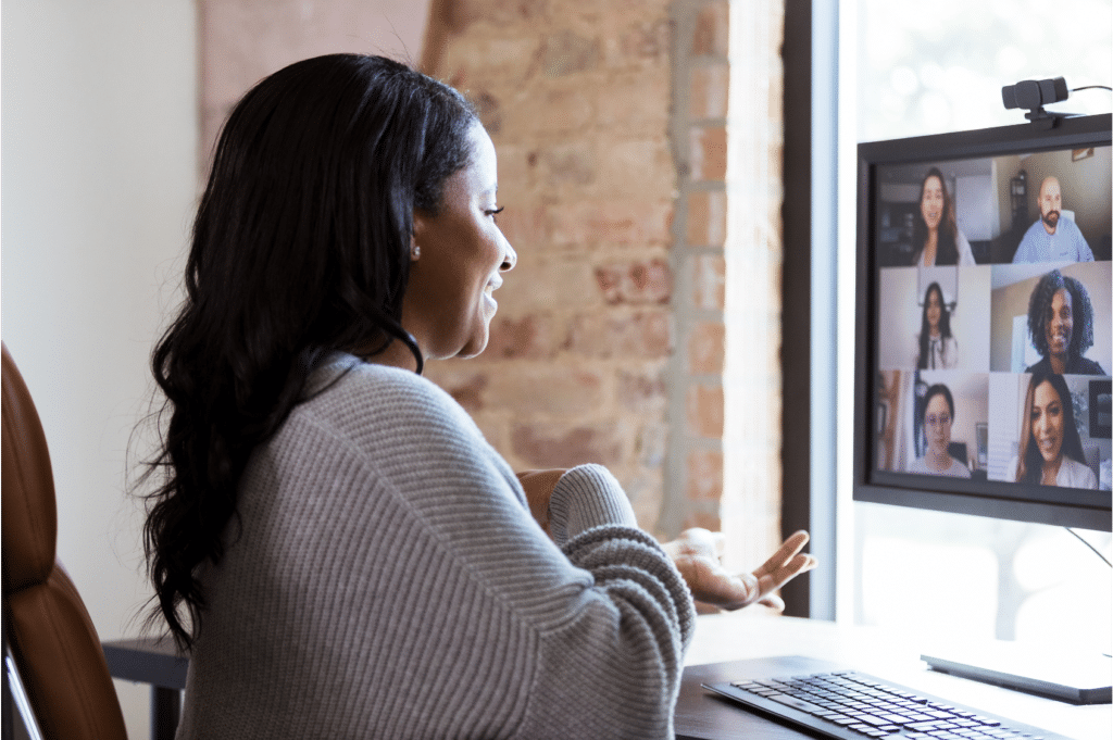 A woman presents herself energetically during a video meeting.