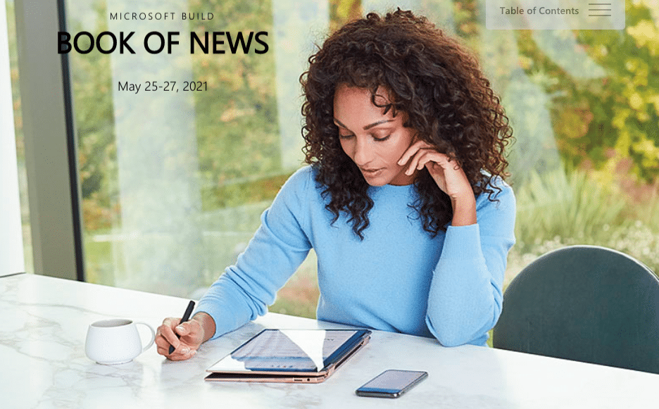 Image from the Microsoft Build 2021 Book of News shows a woman reading the announcements on her tablet.