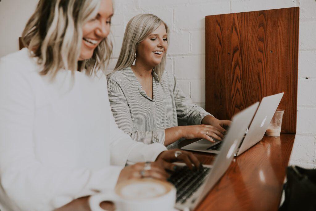 Two women working together enjoy the ease of getting their work done without big time constraints.
