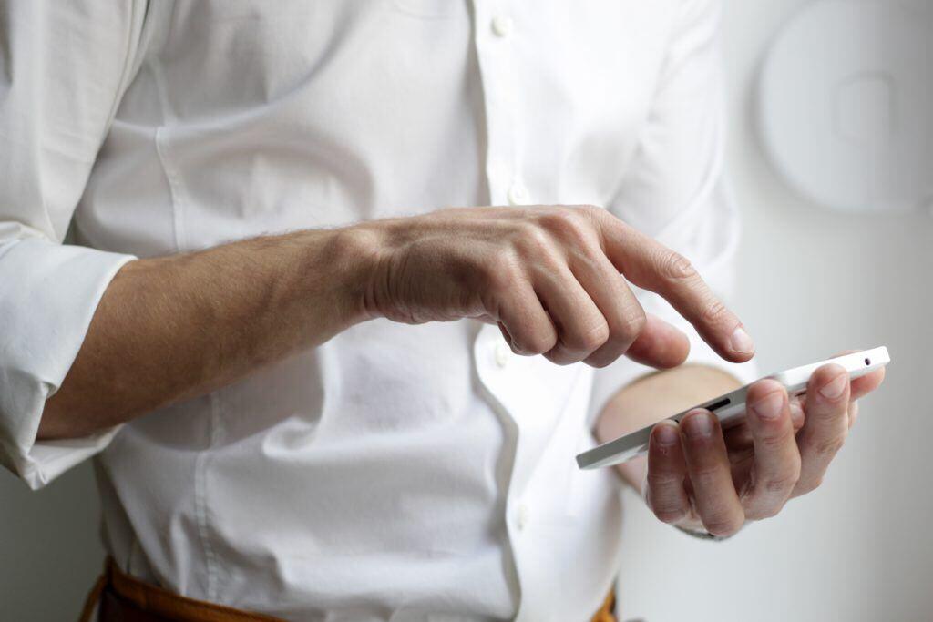 Picture shows a man taking good care of his phone to prolong its life.