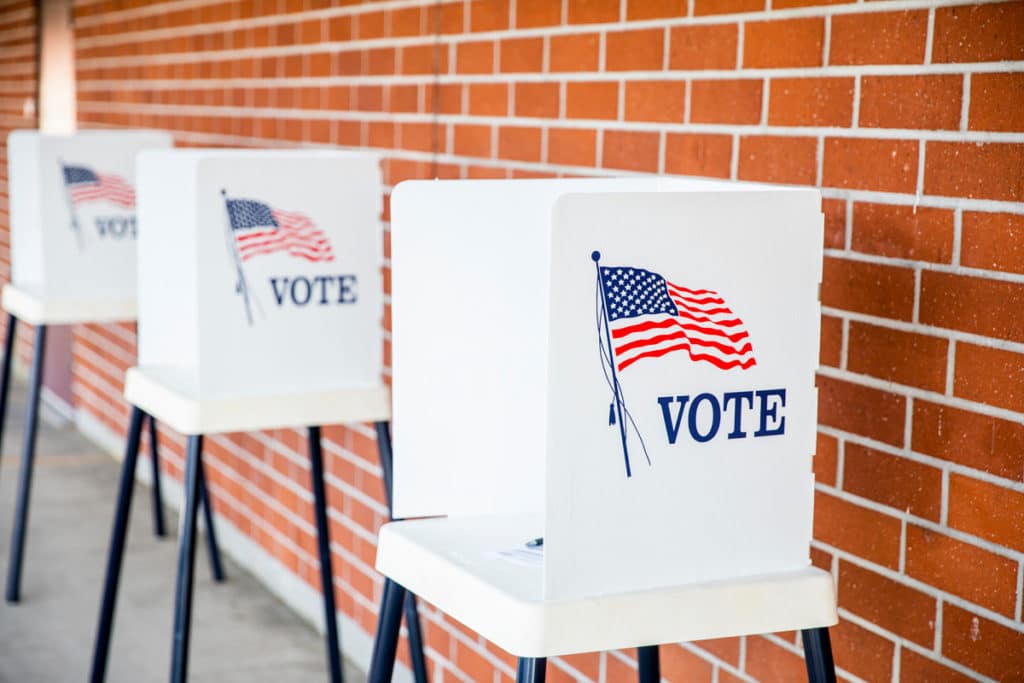 Picture shows voting booths in a secure democracy.